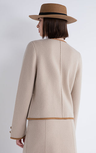 Camel jacket back view with contrast hem band and center back seam