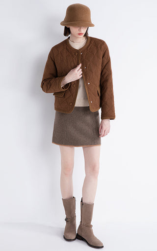 Brown quilted short jacket worn with button front and ribbed cuffs