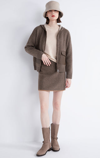 Dark camel hooded jacket and matching skirt-length look; zip front and sheepskin pocket panels