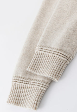 Beige knit cuff with ribbed trim on down coat sleeve