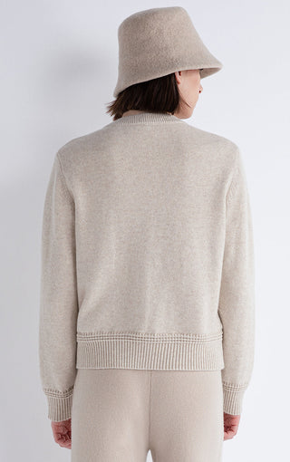 Beige knit puffer coat back view with ribbed waistband and matching hem cuffs