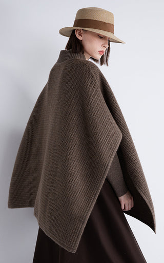 Dark brown wool-cashmere cape, side view, zip front and shearling-trim back hem