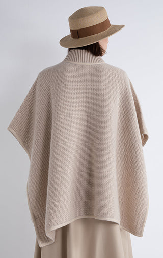 Beige cape back view, zip-front design and shearling-trim hem border