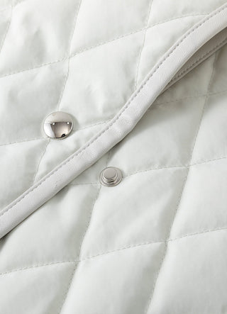 Light greige jacket close-up with snap buttons and edge-stitching at placket