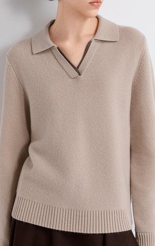 Close-up of taupe wool-cashmere polo knit with contrast trim at V-neck placket