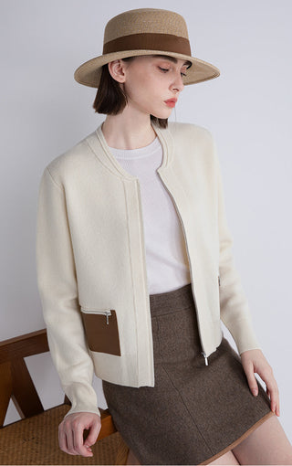 Beige zip cardigan with brown leather pocket trim and front zipper detail