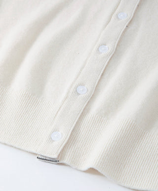 Beige cardigan button placket detail with ribbed hem
