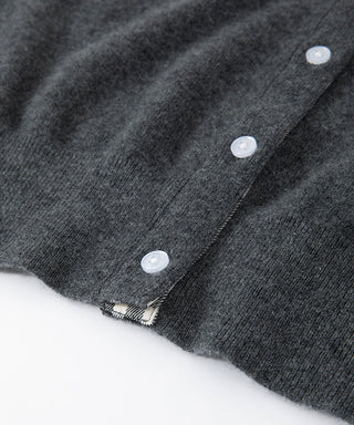 Close-up of grey cardigan knit with white button front