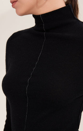 Black cashmere turtleneck close-up with shimmering bead chain along center