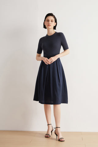 Deep blue wool-silk midi dress with short sleeves, beaded waist detail, and gathered skirt