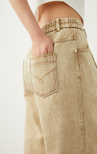 Camel denim back patch pocket with contrast topstitching on wide-leg pants